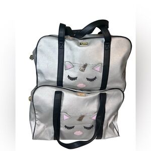 A pair of Betsey Johnson Unicorn Slate large weekender travel bags vacation